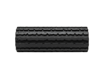 Cylindrical ridged dark gray foam roller against a black backdrop
