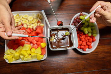 Fruit fondue with chocolate and fresh sliced fruits