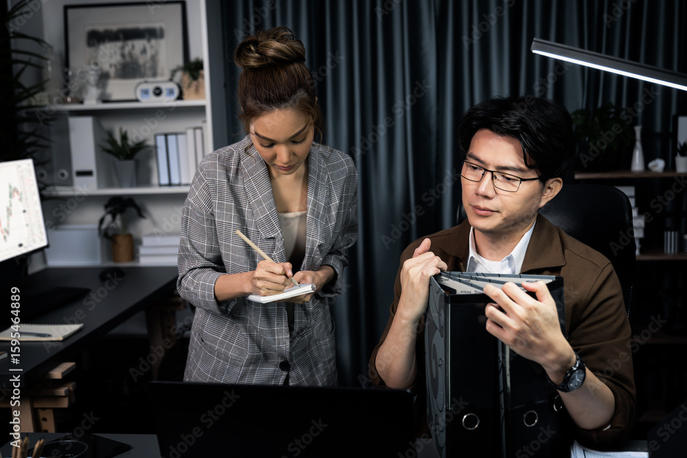 Poster serious face of manager with coworker discussing overworked folder paper at over late night, writing