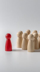 Red figure stands out from wooden figures standing group