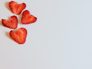 Heart shaped strawberry slices on white background. Space for text.