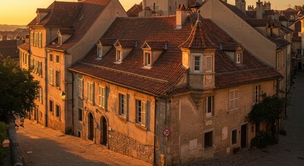 A picturesque old town at dawn. Golden light bathes historic buildings