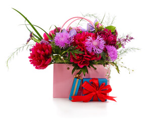 Bouquet of flowers in a basket and gifts.