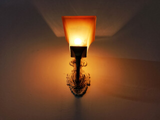 Ornate Wall Lamp with Frosted Glass Shade and Decorative Brass Base