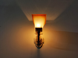 Ornate Wall Lamp with Frosted Glass Shade and Decorative Brass Base