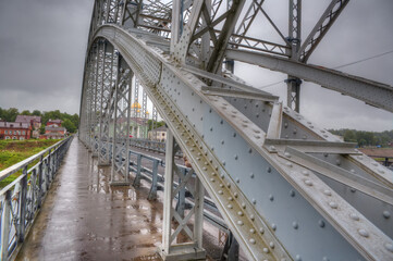 Arched bridge made of metal structures in the city of Borovichi, Russia.