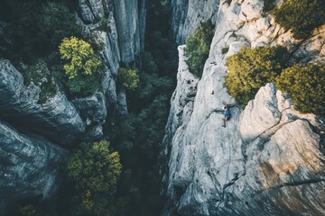 Stunning drone view captures rock climber scaling canyon walls during golden hour, Epic drone shot of canyon and rock climber on tall mountain side