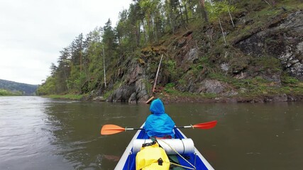 Enjoy an exhilarating kayaking adventure on a tranquil river surrounded by vibrant greenery and majestic cliffs, perfect for nature lovers and outdoor enthusiasts seeking excitement