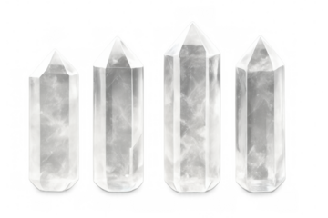 Varied-size clear quartz crystals standing vertically, symbolizing healing energy against translucent minimalist backdrop