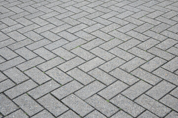 Stone wall with much gray bricks of the modern building.