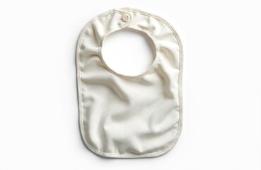 Cream colored baby bib made of cotton textile with simple fastener. A clean, isolated object showcasing garment design for infants, useful for mealtime protection during feeding or teething.