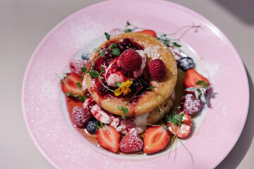 Midsummer Berry Pancakes with vanilla
mascarpone, maple syrup and fruits. Pink plate, aesthetic desert, preppy style sweets