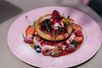 Midsummer Berry Pancakes with vanilla mascarpone, maple syrup and fruits. Pink plate, aesthetic desert, preppy style sweets	