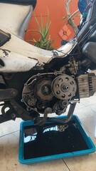 Detailed close-up of a motorcycle engine with its cover removed, revealing internal gears and...