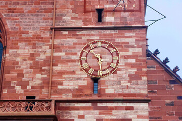 Clock of the Basler Munster (Basel Minster cathedral), Basel, Switzerland. Built between the years...