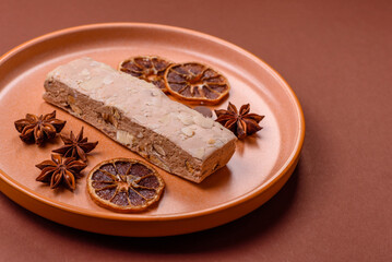 Nougat or white caramel with hazelnuts and pistachios and citrus pieces. White nougat with nuts