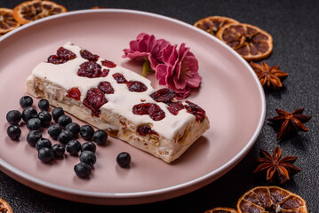 Nougat or white caramel with hazelnuts and pistachios and citrus pieces. White nougat with nuts