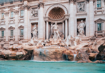 The famous Di Trevi Fountain in the evening. A beautifully illuminated building with marble...