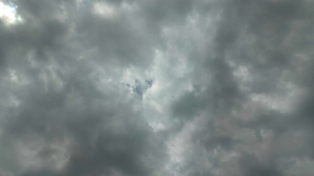 Timelapse of dark storm clouds clearing to reveal a sunny blue sky