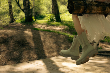 Woman swinging on wooden swing outdoors
