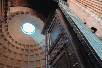 The interior of the Pantheon in Rome. The incredible 8,5 ton door from brozne. Famous Oculus, which lets in light but keeps out rain.