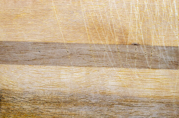 Old wood texture with visible scratches and marks in natural brown color