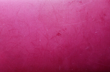 Rich pink matte surface texture with fine scratches and worn abstract background