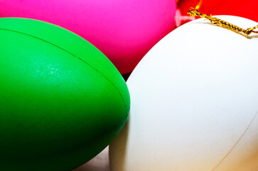 Bright matte Christmas balls in green white and pink closeup creating festive mood