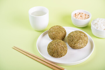 Rice balls with filling and greens topping in a plate