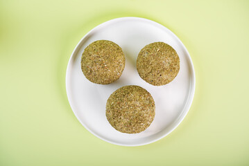 Rice balls with filling and greens topping in a plate