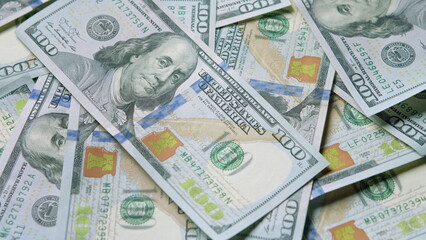 A Stack of One Hundred Dollar Bills Resting on a Surface for Various Financial Uses