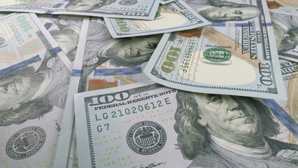 Scattered US Dollar Bills Resting on a Table Surface for Examination and Analysis