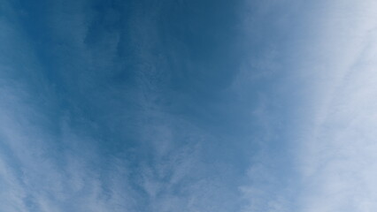 Time lapse. A clear blue sky with fluffy clouds evokes feelings of peace, tranquility, and serenity