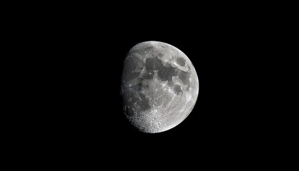 Fototapeta premium close up shot of a waxing crescent moon against a pitch black night sky detailed craters and surface textures are visible in this minimal and captivating lunar image