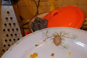 Dirty dishes, plates, lids before washing in water