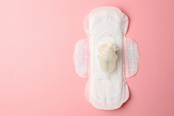 Eco-friendly menstrual cup and other feminine hygiene products on a bright background