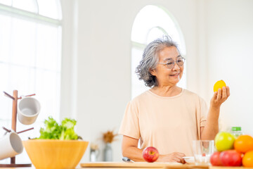 Portrait of Happy Asian senior woman having dinner at home. Elderly woman enjoy healthy lifestyle...