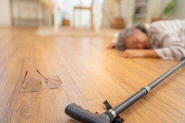 Asian senior woman suffering from heart attack or stroke symptom unconscious on the floor at home....