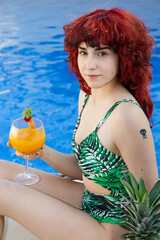 Relaxed young woman enjoying a day at the pool in summer