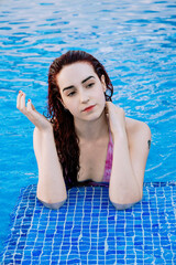 Relaxed young woman enjoying a day at the pool in summer