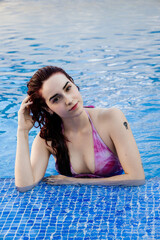Relaxed young woman enjoying a day at the pool in summer