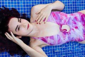 Relaxed young woman enjoying a day at the pool in summer