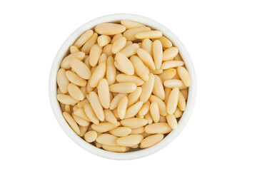 Shelled European pine nuts in ceramic bowl isolated on white background with full depth of field. Top view. Flat lay