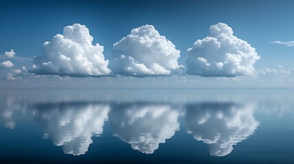 Calm clouds mirrored in a serene body of water.