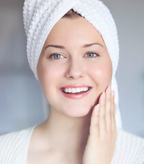 Beauty routine, morning skincare and wellness. A happy smiling beautiful woman with blue eyes and a...