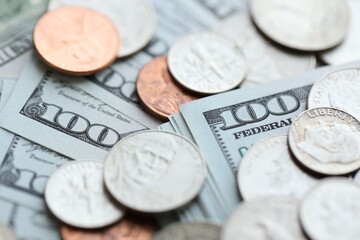 Many hundred dollar bills and US cents coins. Different coins and banknotes.
