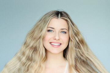 Hairstyle, natural beauty and hair care, smiling blonde woman with blue eyes and wavy hair, posing...