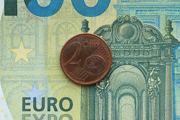 European currency euro cent coin lies on euro banknote bill