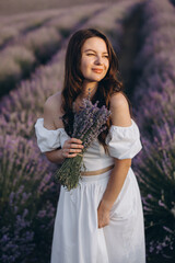 Woman holding lavender bouquet in a lavender field