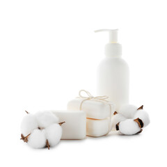 Soap bars, bottle of skincare product and cotton flowers isolated on white